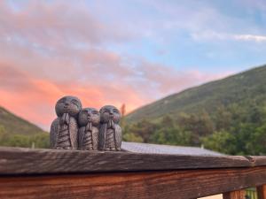a group of three angel statues sitting on a fence at Camping White Rock in Castellane