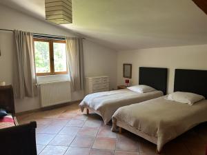 a bedroom with two beds and a window at Camping White Rock in Castellane