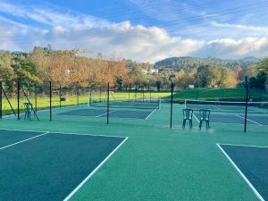 a tennis court with two tennis courts at Quinta Escondida da Avessadas in Avessadas