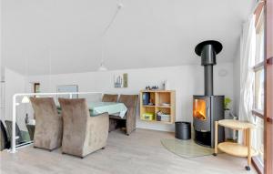 a living room with a table and a fireplace at Holiday Home Marina Vej Egernsund Ii in Egernsund