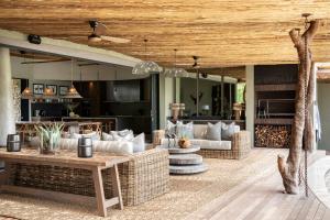an outdoor living room with couches and a table at Fifty-Five Mjejane in Hectorspruit