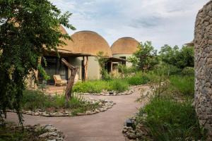 an exterior view of a house with domes at Fifty-Five Mjejane in Hectorspruit