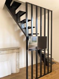 a black spiral staircase with a television on it at Plein Centre Bastia in Bastia