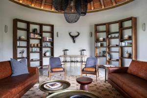 a living room with couches and chairs and a table at Fifty-Five Mjejane in Hectorspruit