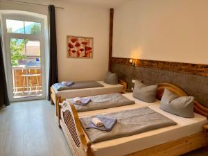 three beds in a room with a window at Gasthof Löwen in Pfronten