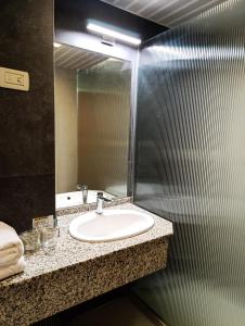 a bathroom with a sink and a mirror at Hotel Metropol – Metropol Lake Resort in Ohrid