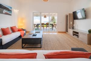 un salon avec un canapé et une télévision dans l'établissement Lanzahost Villa Ona, à Costa Teguise