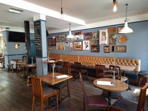 a dining room with wooden tables and chairs at Old Ship Inn Hackney in London