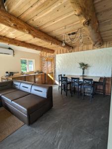 a living room with a couch and a table at Brīvdienu māja "Saules Avoti" in Talsi +22 photos