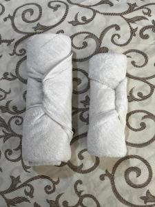 a pair of white socks sitting on a bed at Čajića avlija in Obrenovac +31 photos