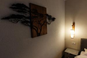 a picture of a tree on the wall in a hotel room at Odaia Vanatorului Transalpina in Şugag