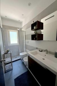 a bathroom with a tub and a toilet and a sink at Casa dei Venti in Porto Palo