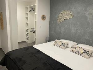 a bedroom with a large bed with white sheets and pillows at Villa JOPI 3Ch piscine plage entierement climatisée in Le Grau-dʼAgde +19 photos