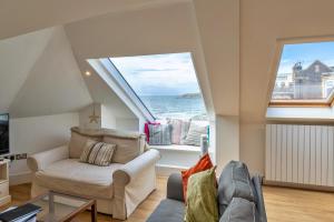 a living room with a couch and a large window at Finest Retreats - Ocean Lookout - Luxury Woolacombe Beach Apartment with Sea Views in Woolacombe