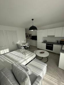 ein Wohnzimmer mit einem Bett und einer Couch und eine Küche in der Unterkunft Студия в комплексе Thalassa с видом на горы in Elea