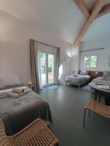 a bedroom with a bed and a couch and a table at Les chambres du Chateau de Fenestrelle in Aubagne