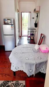 a kitchen with a table with a white table cloth on it at ЦЕНТРЕ ОТДЫХА Costa brava ИССЫК-КУЛЬ in Tegirmenty
