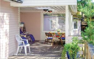 a patio with chairs and a table on a house at Two-Bedroom Holiday Home In Yngsjo in Yngsjö +2 photos