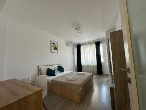 a bedroom with a bed and a table in it at RS Q Studio in Iaşi