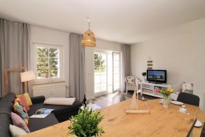 a living room with a couch and a table at Ostseeresidenz Appartements Wischuer Fewo 23 in Wischuer
