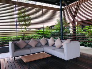 a couch with pillows sitting on a porch at The PeAk Residence, Multi-Apartment by Emma in Phnom Penh