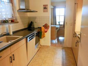 a kitchen with a sink and a stove top oven at Appartementanlage Am Grün 13 in Wittenbeck