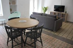 a living room with a table and chairs and a couch at El Terrer 1834 Apartament in Santpedor