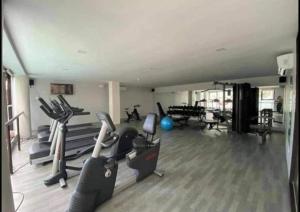 a gym with treadmills and exercise bikes in a room at 2 Bedroom Condo Iloilo City in Iloilo City