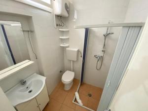 a bathroom with a shower and a toilet and a sink at Zanella Bed in Torre Lapillo