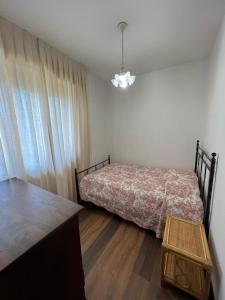 a small bedroom with a bed and a table at Loft delle meraviglie in Vallecchia