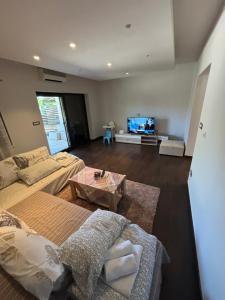 a living room with a couch and a tv at Apartment Verano in Njivice
