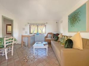 a living room with a couch and a table at Villa del Golfo in Olbia