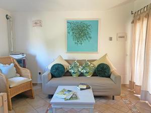 a living room with a couch and a table at Villa del Golfo in Olbia +42 photos