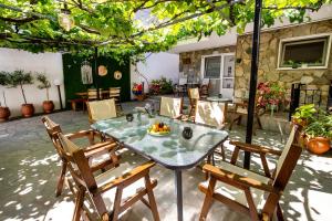 a table with a bowl of fruit on it on a patio at Famelia Studios Lampiris in Potos