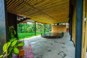 an external view of a house with a large wooden ceiling at Let's Get Lost Ubud in Ubud