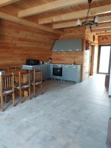 a large living room with a kitchen and a table at A Frame Panoramic Apuseni in Bistra +46 photos