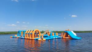 a row of inflatable slides in the water at Szczupak in Sztabin