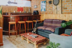 a living room with a couch and a bar at Qumir Packers in Huaraz