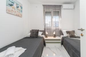 En eller flere senge i et værelse på Villa Marimela luxury apartments + 160 billeder