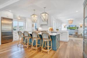 a kitchen with a blue island with bar stools at 6 BD Smith Mountain Lakefront Escape sunset in Moneta
