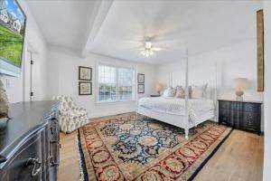 a white bedroom with a bed and a rug at 6 BD Smith Mountain Lakefront Escape sunset in Moneta +32 photos