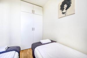 Posteľ alebo postele v izbe v ubytovaní Labo Apartment Żelazna Brama