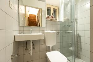 a bathroom with a toilet and a sink and a mirror at House Draza in Biograd na Moru