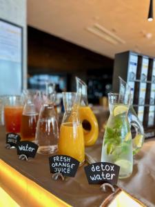 a bunch of drinks in vases on a counter at Sea Star Budva in Budva