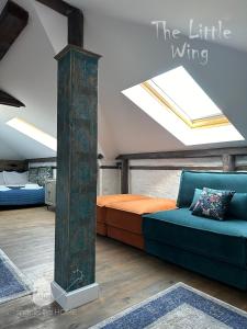 a attic bedroom with a bed and a skylight at Пространства за гости Синият час - апартамент Little Wing in Ruse