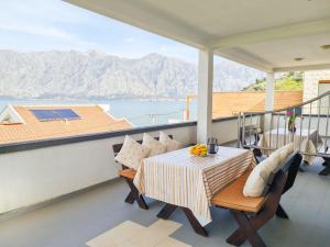 a balcony with a table and a view of the mountains at Step to Kotor bay St-oliv in Kotor