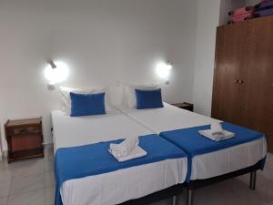 a bedroom with a large bed with towels on it at Annabel Apartments in Theologos +21 photos