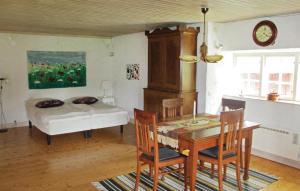 a room with a table and a bed and a table and chairs at Nice Home In Visby With Wifi in Endre
