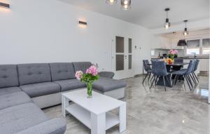 a living room with a couch and a table with flowers at 4 Bedroom Nice Home In Slivnica Donja in Knežević