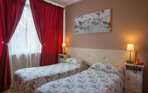 A bed or beds in a room at Ankon Hotel